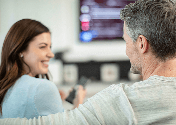 man and woman watching TV